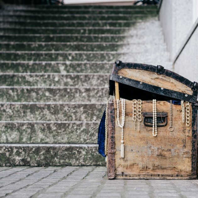 brown jewelry box beside concrete stairs